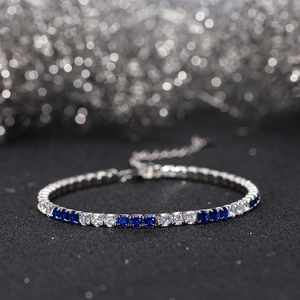 Detail of a 925 silver tennis bracelet with alternating blue and white cubic zirconia