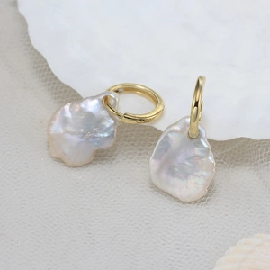Handmade baroque pearl earrings with gold S925 sterling silver hoops on lace background