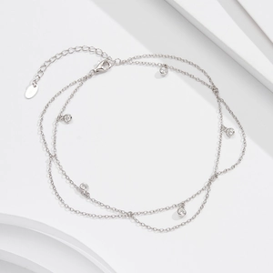 Detail of S925 sterling silver double-layer anklet with zircon charms and lobster clasp