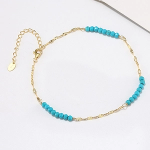 Detail of S925 sterling silver butterfly anklet with turquoise beads and gold lobster clasp