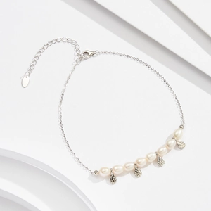 Detail of S925 silver anklet with seven freshwater pearls and four teardrop charms