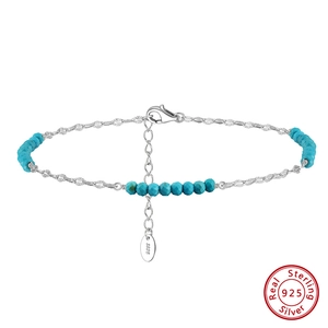 Macro detail of S925 sterling silver tag and turquoise blue beads on the anklet