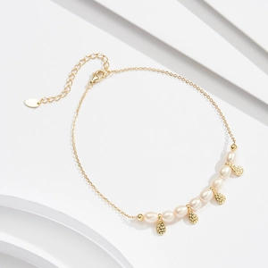 Detail of S925 silver anklet featuring freshwater pearls and hammered gold pendants
