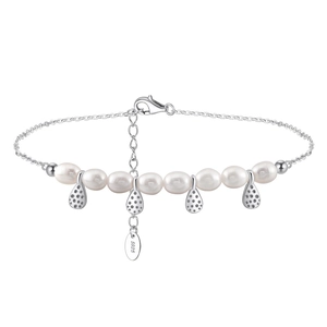 Macro detail of S925 sterling silver anklet with freshwater pearls and drop charms