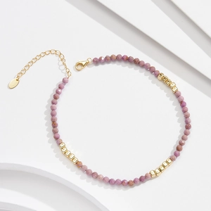 Macro shot of S925 silver anklet with purple mica beads and golden square accents