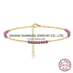 Detail of S925 sterling silver gold-plated anklet with purple faceted crystal beads