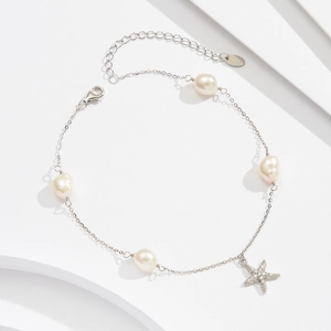 Macro view of S925 sterling silver anklet featuring fresh water pearls and starfish charm