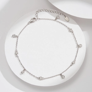 Detail of S925 sterling silver anklet with nine bezel-set cubic zirconia stones