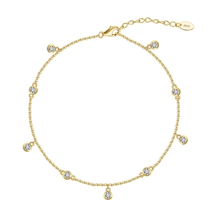 Detail of S925 sterling silver gold anklet featuring nine round cubic zirconia charms