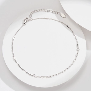 Detail of S925 sterling silver paperclip anklet with lobster clasp and oval tag