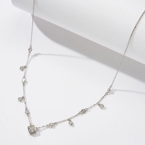 Detailed view of S925 sterling silver chain with square zirconia pendant on white pedestal