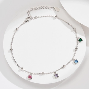 Macro detail of S925 sterling silver anklet with colorful square zircon stones and clasp