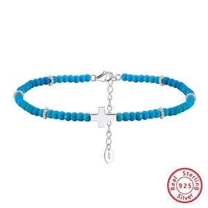 Macro shot of S925 sterling silver stamp on a turquoise beaded cross charm anklet