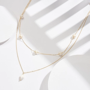 Double-layered S925 silver pearl necklace featuring a gold chain and unique baroque pendant