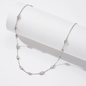 Detail of 925 silver station necklace with round, square and marquise-cut crystals