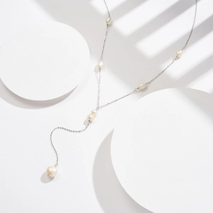 Detail of S925 silver Y-shaped lariat necklace with lustrous freshwater pearls on white