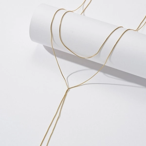 Minimalist gold S925 sterling silver snake chain necklace displayed on a white stand