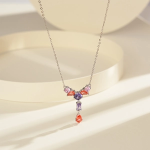 Macro detail of S925 silver necklace with tassel of purple and pink zircon stones