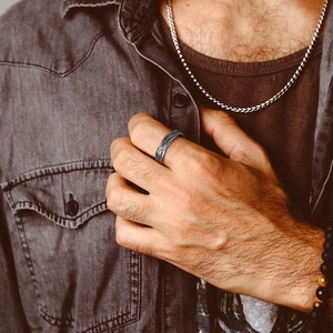 Detail of men's S925 silver chain link ring with vintage braided texture on finger