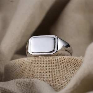 Detailed macro view of a polished silver signet ring with a rectangular mirror surface