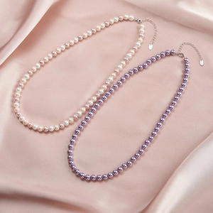 S925 silver pearl necklace with colorful pink and purple pearls on pink silk background