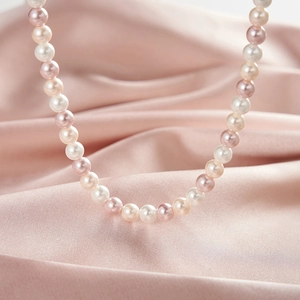 Macro detail of colorful S925 silver pearl necklace with white pink and purple pearls