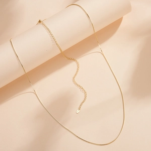 Detail of S925 sterling silver stamp on golden box chain necklace with adjustable link