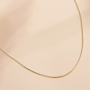 Macro shot of 18K gold-plated S925 sterling silver box chain with smooth square links