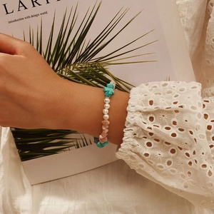 Natural stone and pearl bracelet with turquoise, pink quartz and silver beads on a model