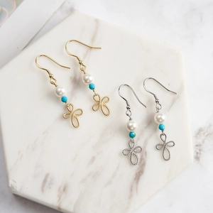 Retro 925 silver drop earrings with shell pearl and turquoise on marble surface