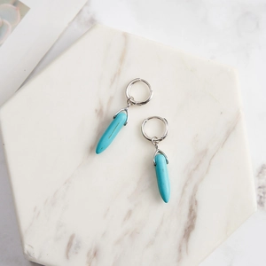 Detailed close-up of S925 silver hoop earrings with turquoise bullet-shaped pendants