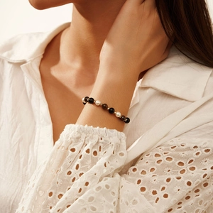 S925 silver bracelet featuring tiger eye, obsidian, and pearls on a model wrist