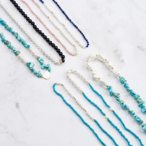 S925 silver beaded necklaces with pink opal, pearls and heart pendant on marble
