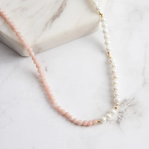Detail of pink natural stone beads and white pearls on an asymmetric S925 silver necklace
