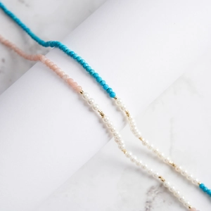 Macro detail of S925 silver beaded necklace with pink stones and white pearls