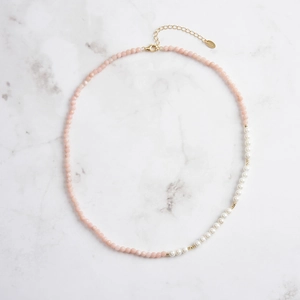 Vintage S925 silver necklace with pink gems and white pearls on marble background
