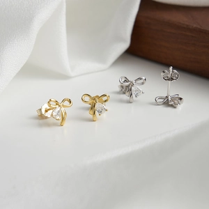 Elegant 925 sterling silver bow earrings with pear-shaped zircon stones in gold and silver