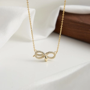Détail du pendentif serpent doré avec pavé de zircons blancs et finition polie chic