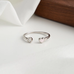 Gros plan du poinçon S925 sur bague ajustable en argent avec cœur rose et zircon