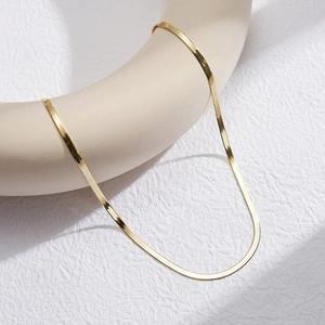 Detail of 18K gold S925 sterling silver snake chain showing smooth herringbone weave