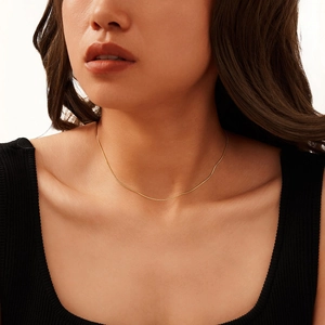 Minimalist S925 sterling silver snake bone chain necklace worn on a model's neck