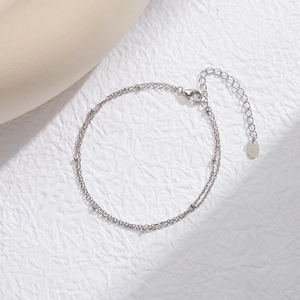 Macro detail of S925 sterling silver double layer bead bracelet with lobster clasp and tag