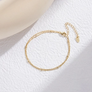 Close-up of gold S925 sterling silver double-layer bead chain bracelet with lobster clasp