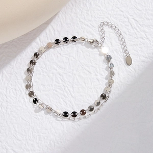 Macro shot of S925 sterling silver double-layer bracelet with sequins and paperclip chain
