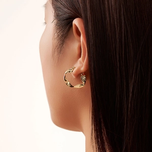 Classic S925 sterling silver gold twisted hoop earrings featuring a modern wavy design