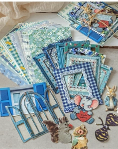 Detailed close-up of vintage floral scrapbooking paper pack with animal stickers