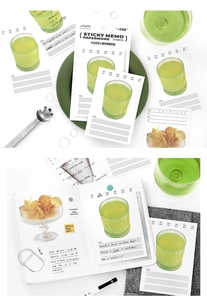 Detail of minimalist green juice cup sticky notes with goal setting and monthly markers