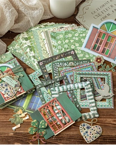 Detail of vintage garden themed scrapbooking paper set with floral frames and die-cut stickers
