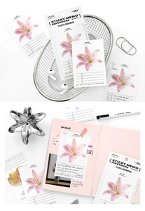 Macro view of PaperMore lily floral sticky notes used in a pink daily planner