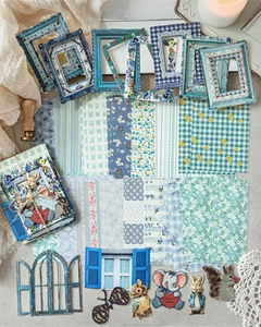 Flat lay of vintage garden style paper scrapbooking kit with floral and animal motifs